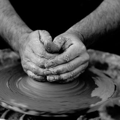 Close-up of hands shaping clay on a pottery wheel